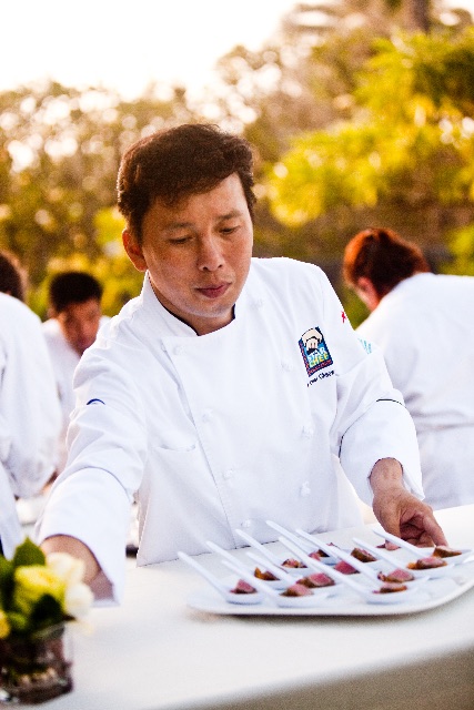 Chef Chai Chaowasaree plating dishes at an event